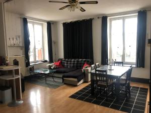 a living room with a couch and a table at Chez Jo in Flize