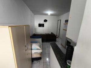 a small living room with a couch and a television at Ed Falcão quadra 2 lote 7 AP 402 in Riacho Fundo
