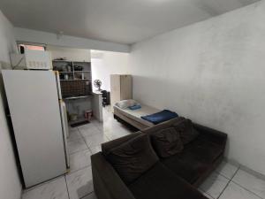 a living room with a couch and a refrigerator at Ed Falcão quadra 2 lote 7 AP 402 in Riacho Fundo