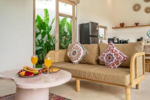 a living room with a couch and a table at Bambola - Stunning New Luxury Villa in Kerobokan with Expansive Pool - Your Dream Home Awaits! in Canggu