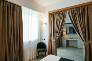 TV a/nebo společenská místnost v ubytování Grand Hotel la Chiusa di Chietri