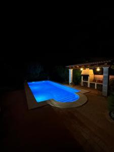 a swimming pool lit up at night at Mallorca Casa Mar Blava in Llucmajor
