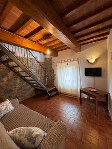 a living room with a staircase and a couch at Agriturismo San Jacopo in Reggello