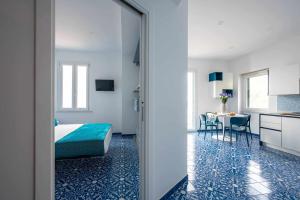 a bedroom with a bed and a table in a room at Blue Amalfi Luxury House - Vista mozzafiato in Amalfi