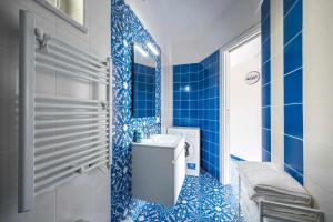 a blue tiled bathroom with a toilet and a sink at Blue Amalfi Luxury House - Vista mozzafiato in Amalfi +19 photos