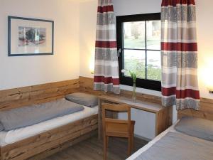 une chambre avec deux lits et une fenêtre dans l'établissement Ferienhaus Nr 27, Kategorie Premium, Feriendorf Hochbergle, Allgäu, à Lechbruck am See 10 autres photos