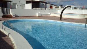 a swimming pool with blue water in a building at Escapada de ensueño Conchaseaview in Playa Honda +19 photos