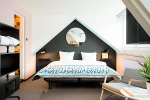 
Een bed of bedden in een kamer bij The Dutch Maastricht
