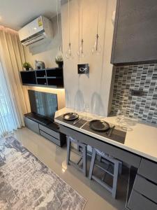 a kitchen with a counter with two sinks in it at Citygate Kamala Condo Paris in Kamala Beach