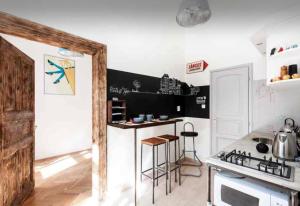 a kitchen with a counter and a stove top oven at Little Whistle in the heart of Jewish district with AC in Budapest +19 photos