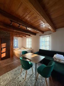 a living room with a table and chairs and a bed at Domek Bomba Zator Graboszyce in Graboszyce