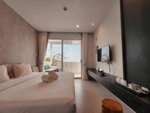 a bedroom with a large bed and a view of the ocean at BBG Beachfront poolvilla 5BR close to Huahin city in Cha Am
