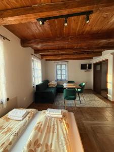 a living room with a bed and a couch and a table at Domek Bomba Zator Graboszyce in Graboszyce