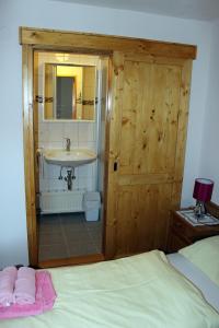 a bedroom with a bathroom with a sink and a bed at Appartements Schmidsendl in Lofer +124 photos