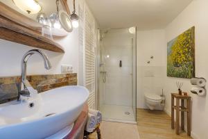 a bathroom with a sink and a shower at homie hotel oechsle & brix in Sommerhausen