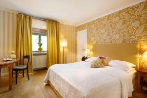 Postel nebo postele na pokoji v ubytování Hotel Goliath am Dom