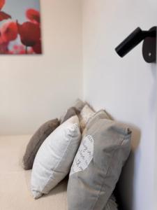 a pillow sitting on top of a bed at CityLink Nest Budapest - Free garage, AC & metro access in Budapest