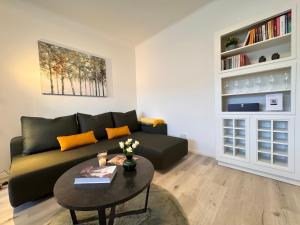 a living room with a couch and a table at CityLink Nest Budapest - Free garage, AC & metro access in Budapest