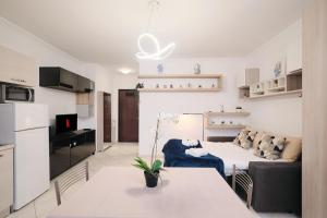 a living room with a couch and a table at Cozy Loft with Spacious Terrace in Lunghezza