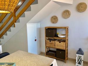 a room with a table and a cabinet with a tv at Aire de Oceano in Costa de Antigua