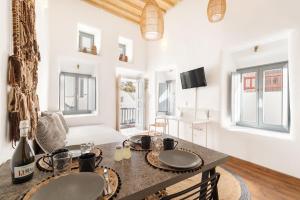 a kitchen with a table with two plates on it at Cove in Mýkonos City +5 photos