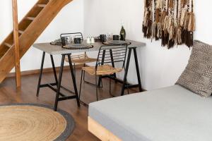 a dining room table with two chairs and a table with a couch at Cove in Mýkonos City