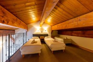 a bedroom with three beds and a balcony at Résidence Les Arolles by Les Etincelles in Arc 2000 +109 photos