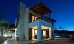 a large house with a balcony at night at Marilia by Vintage Travel in Maleme