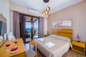 a bedroom with a bed and a table with glasses of wine at Marilia by Vintage Travel in Maleme +26 photos