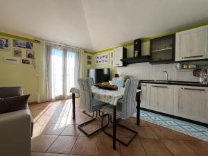 a kitchen with a table and chairs in a room at Villa Sole e Luna - Key to Villas in Valledoria +29 photos