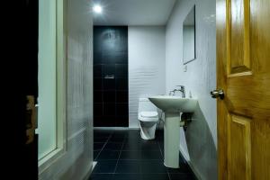 a bathroom with a white toilet and a sink at X GO INN Sukhumvit Soi 20 BTS Asok in Bangkok