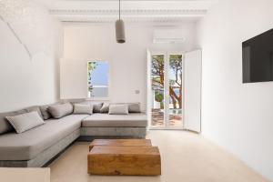 a living room with a couch and a coffee table at Sunset Cove in Agios Ioannis Mykonos