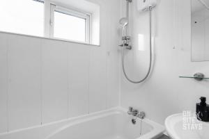 a white bathroom with a tub and a sink at Contractors 4 Bed with Parking in Hatfield