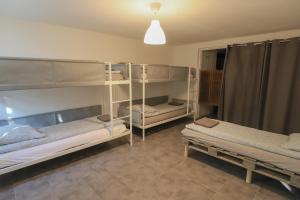 a room with three bunk beds and a pendant light at Crazy Villa Margotterie 58 - Heated pool - 2h from Paris - 30p in La Celle-sur-Loire +55 photos