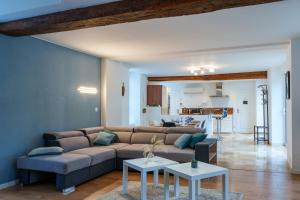 a living room with a couch and two tables at Maison centre Bourgueil avec piscine 8 p in Bourgueil