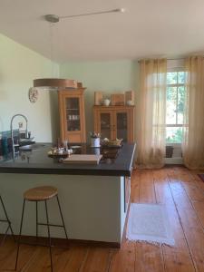 a kitchen with a island with a counter top at Gutshaus Schwarzenhof in Dargun +5 photos