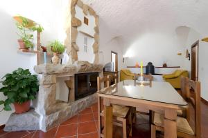a kitchen and living room with a stone fireplace at La Chumbera in Benalúa de Guadix