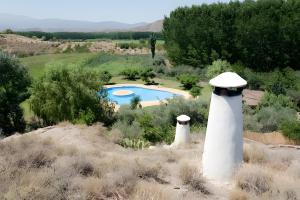 a view of a pool and a lighthouse at La Chumbera in Benalúa de Guadix