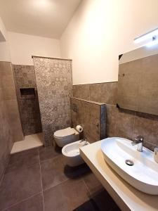 a bathroom with a toilet and a sink at Studio 49 - da Frank in Giardini Naxos +27 photos