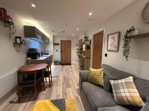 ein Wohnzimmer mit Sofa und Tisch in der Unterkunft Rock Mill - Luxury 1 Bedroom Apartment 20 in Stony Middleton