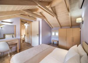 a bedroom with a bed and a desk in a room at Rigilis by Vintage Travel in Nydri +27 photos