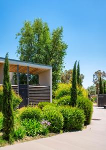a building with bushes and trees in front of it at Costa Nera Beach House in Porto-Vecchio