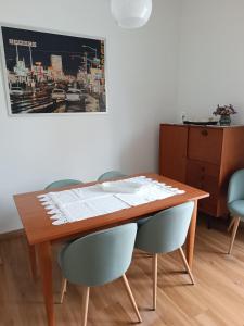 a wooden table with chairs and a picture on the wall at Palacongressi city center in Rimini +33 photos