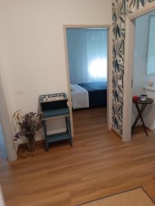 a small room with a bed and a mirror at Palacongressi city center in Rimini