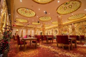 a dining room with christmas decorations on the ceiling at Haveli Banquet & Resort in Ajmer