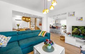 a living room with a blue couch at House Seaside Magnolias in Pirovac