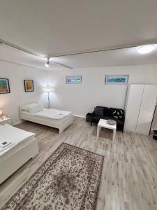 a living room with two beds and a couch at Quartier Wenzelnberg in Langenfeld +60 photos