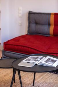 a table with a book on it in front of a bed at Chryssi 02, Comfort & Style, Centrally in Rethymno, close to the beach in Rethymno Town