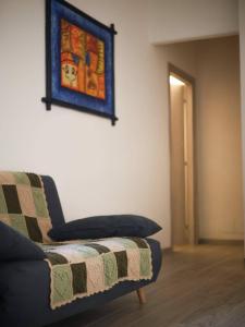 a living room with a couch and a painting on the wall at Casina Viareggina 2 camere in Viareggio