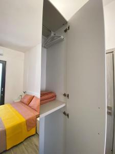 a small bedroom with a bed and a closet at Casina Viareggina 2 camere in Viareggio +29 photos